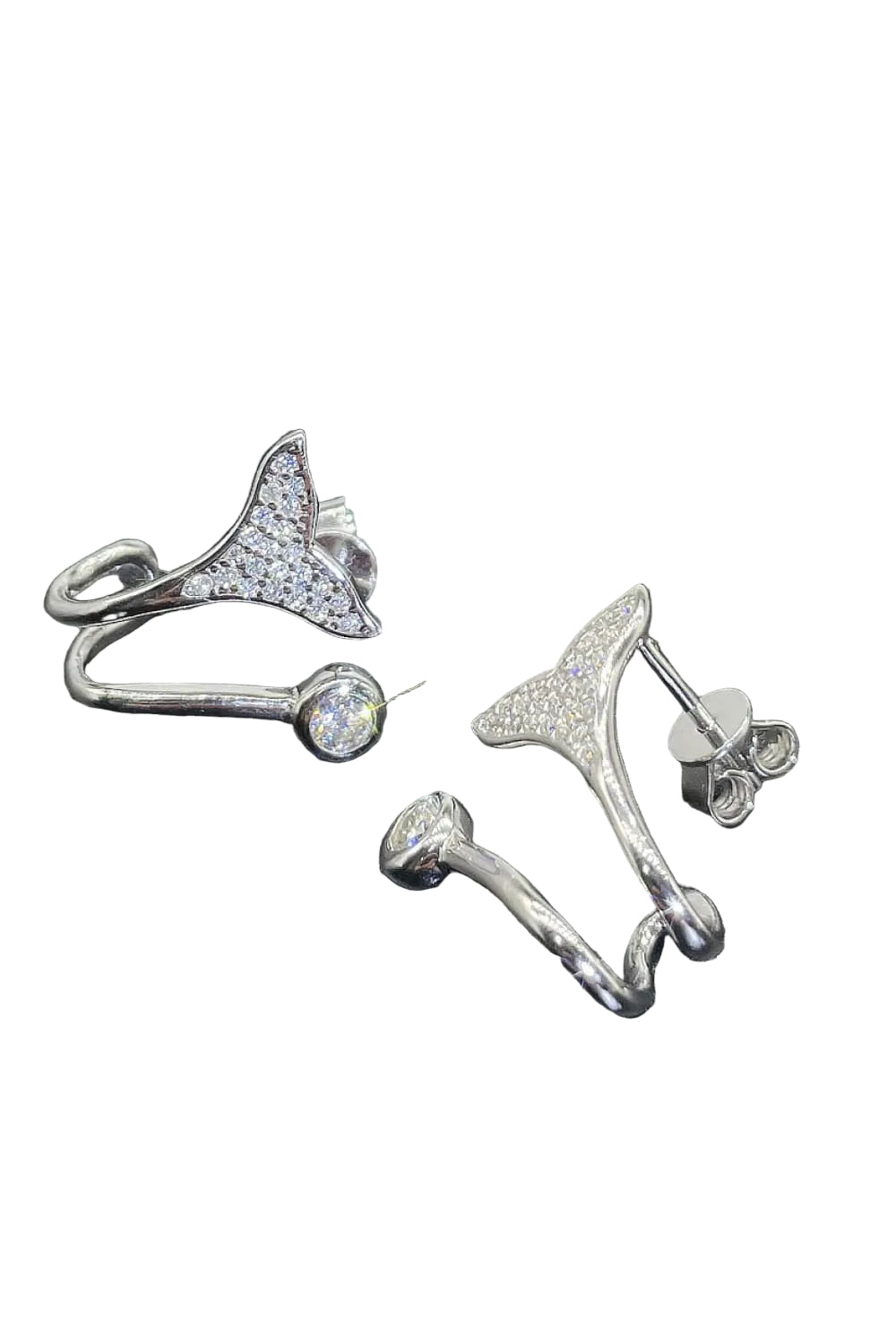 Moissanite fishtail earrings, angled setting and post detail on pure white