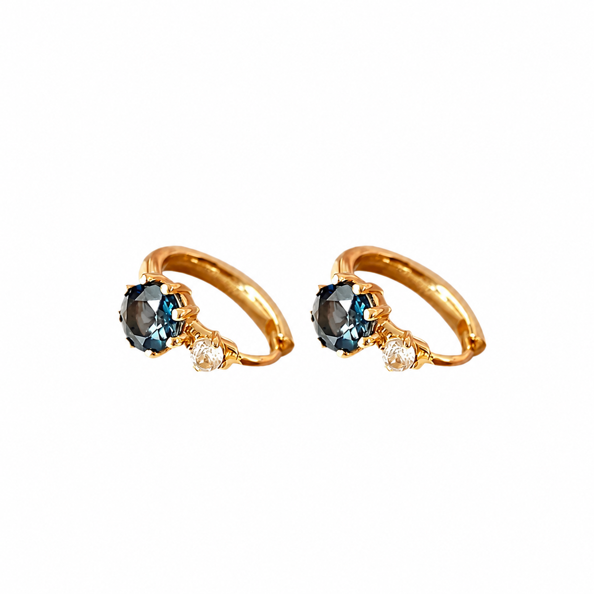 Pair of blue zircon hoop earrings with clear accents in gold-plated sterling silver on white